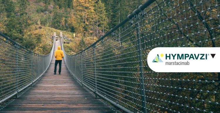 Image of male actor walking on a bridge with mountains with HYMPAVZI logo overlay on the right.